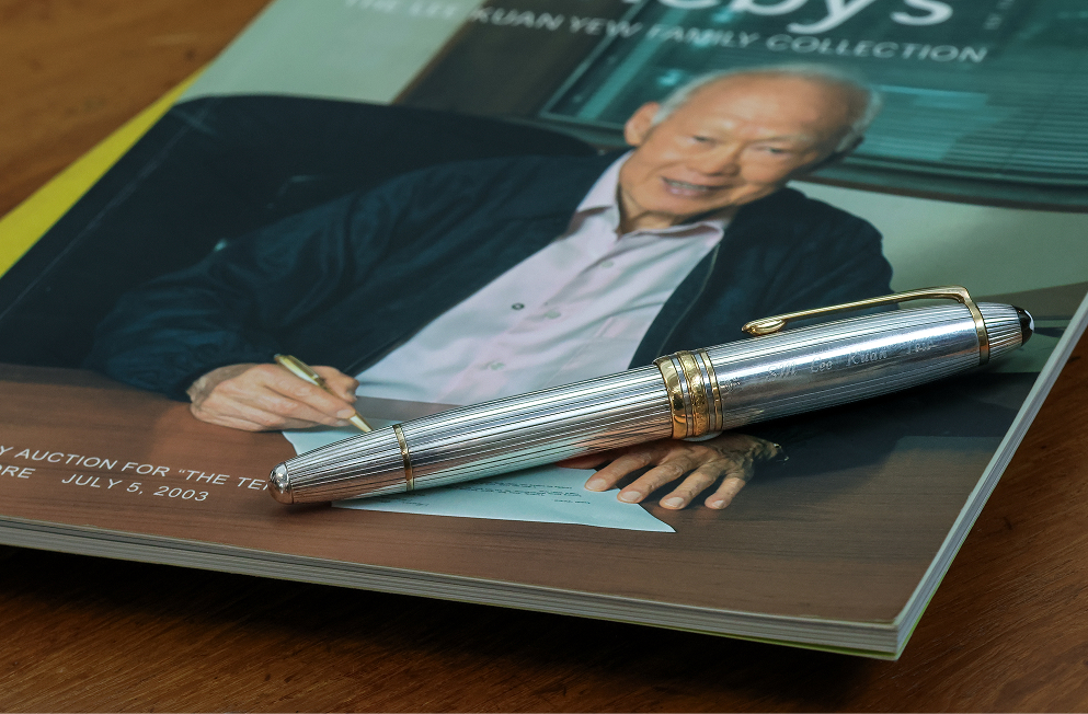 An auction catalogue and pen